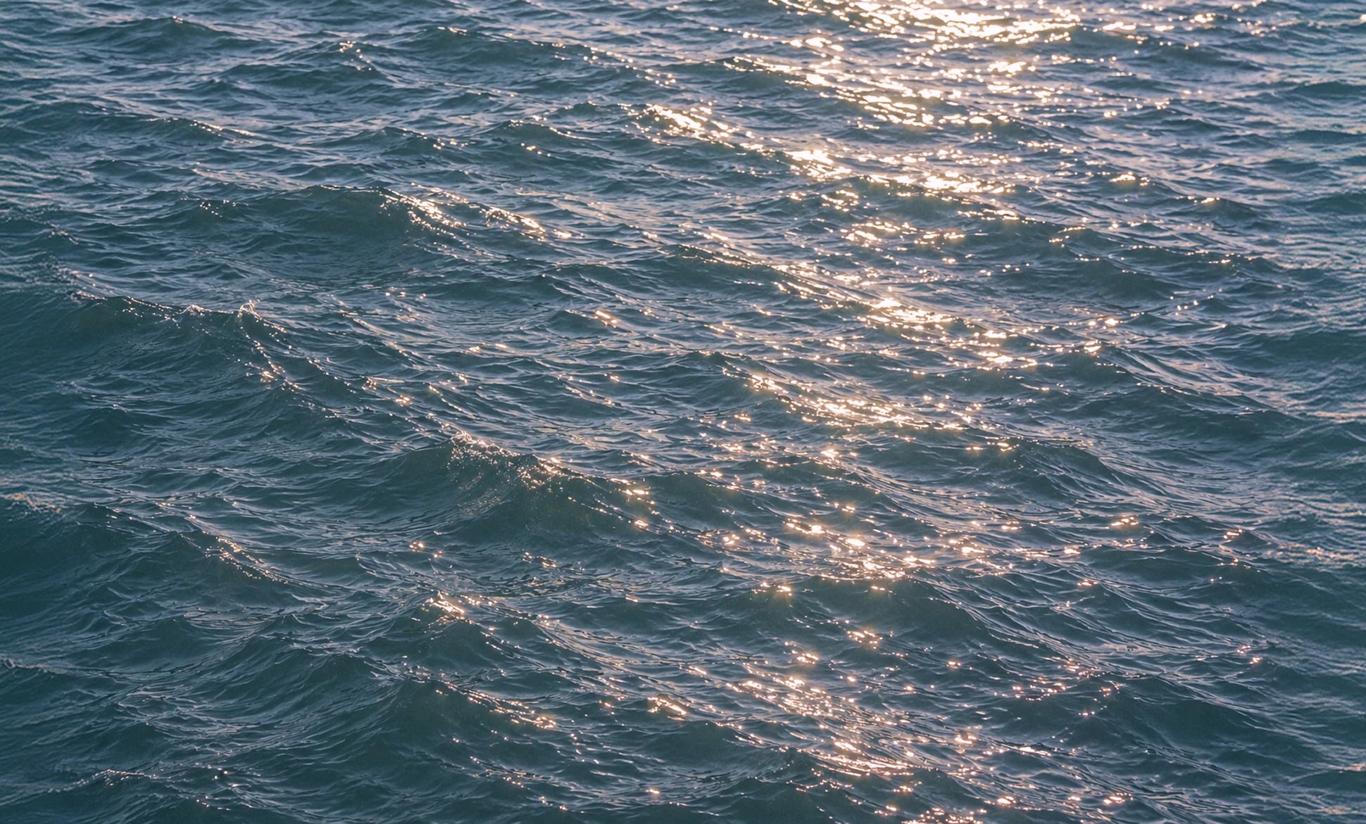 Sunlight shimmering on blue-green sea water