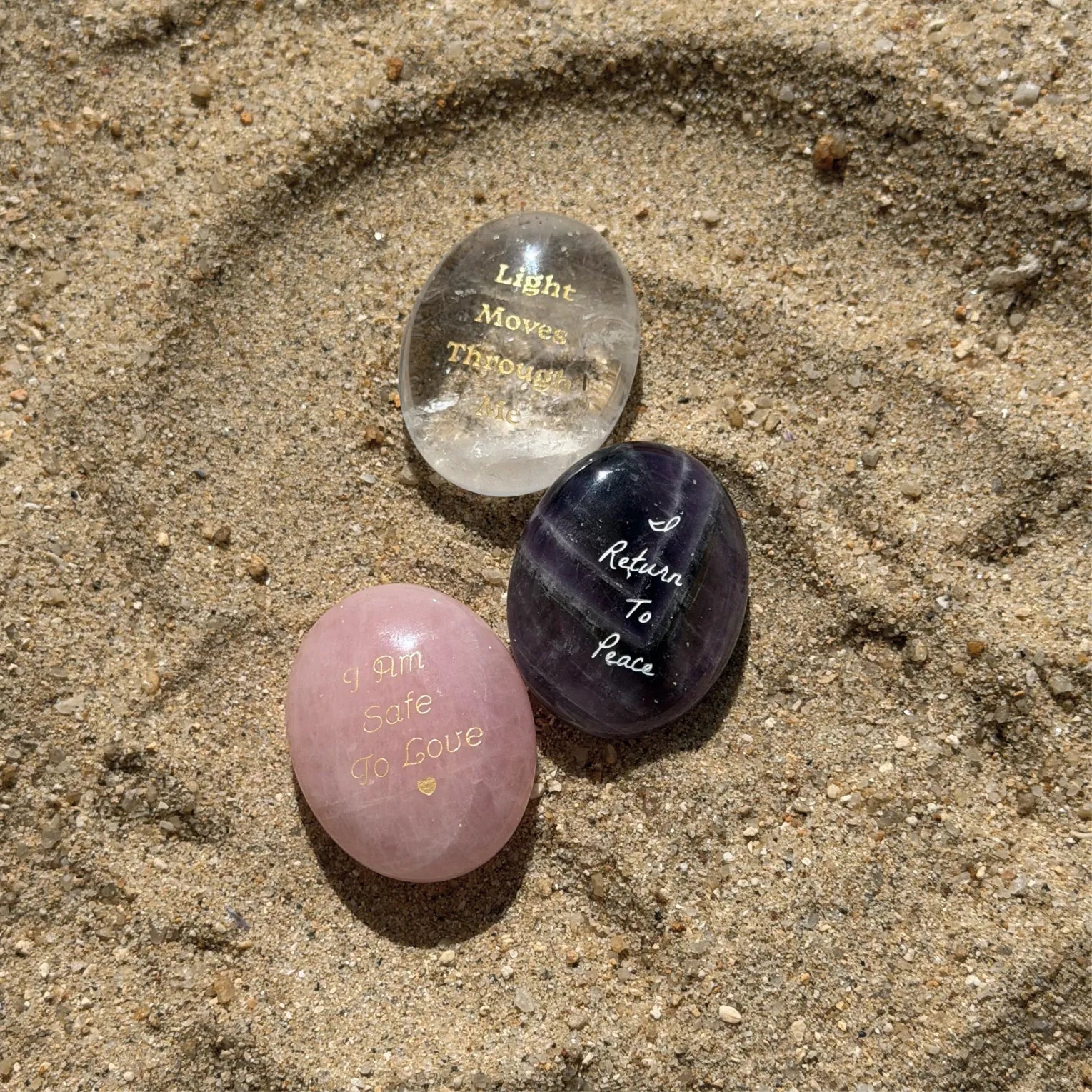 Soft Return three-stone set photographed on sand